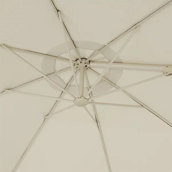 Close-up of a cream patio umbrella with a detailed view of the canopy and frame.